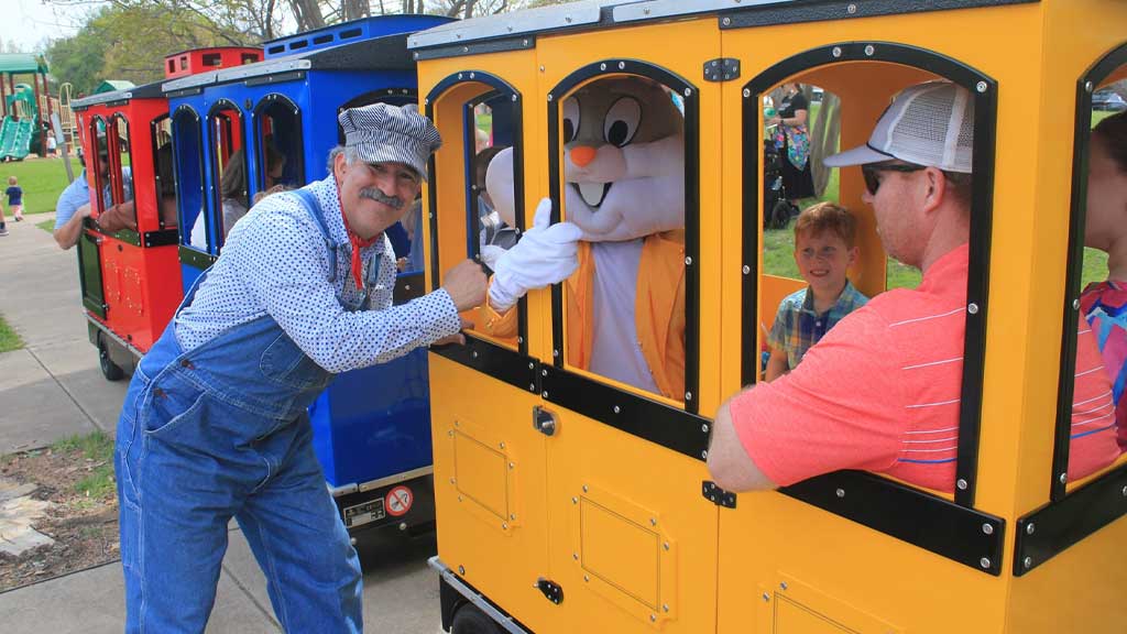 Mini Express trackless train operating in an amusement park, offering safe and fun rides for children and families