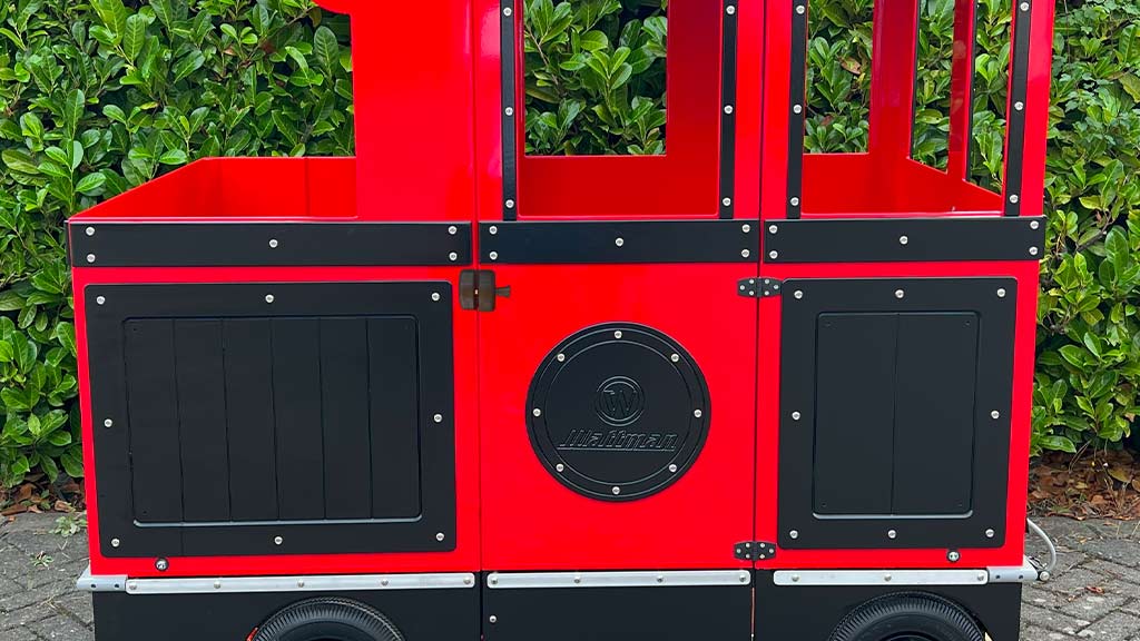 Mini Express trackless train displaying custom advertising panels with sponsor branding and promotional messages